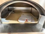 a pizza oven with a pizza inside of it