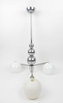a chandelier with three balls hanging from the ceiling