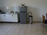 a small kitchen with a refrigerator and a table in it