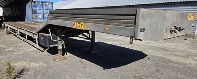 an image of a flatbed trailer parked in front of a building