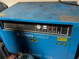 an image of a blue machine sitting in a room next to a gas can