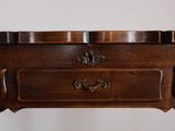a small wooden table with a drawer on top of it