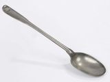 spoon on a white surface with a silver handle on it