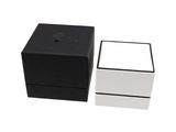 two black and white boxes sitting next to each other on a white surface