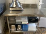 a stainless steel table in a kitchen with pots and pans on it