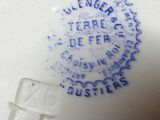 a close up of a white plate with blue writing on it