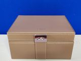 a brown box with a lock on top of a white table
