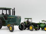 two toy tractors that are sitting next to each other