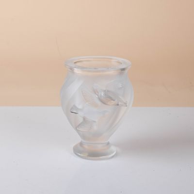 a clear glass vase sitting on a white surface