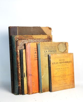several books are stacked on top of each other on a white surface
