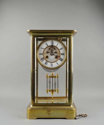 Pendule cage en laiton et verre.