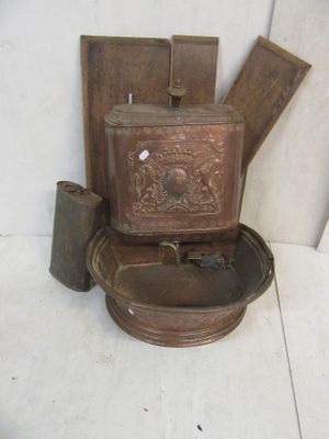 a toilet that has a metal bowl on top of it