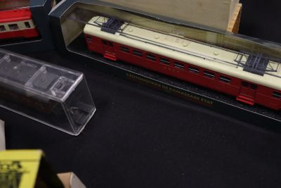 three model trains on display on a black table