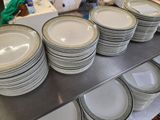 a lot of plates that are stacked on a shelf