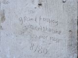 a cement plaque with writing on it on the sidewalk