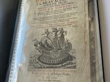 an old book with a picture of a boat on it