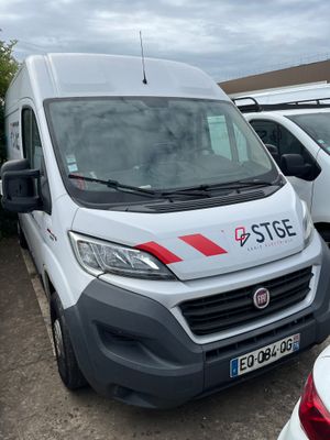 a white van that is parked next to other cars