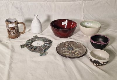 a lot of different bowls and cups on the table