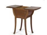 a wooden table with a drop leafed top and legs