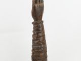 an image of a wooden statue of a hand holding a star