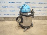 the vacuum is sitting on the floor in front of a wall