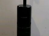 a black toilet brush holder on a white counter