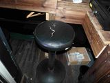 a black stool sitting in the corner of a room