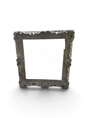 an old silver picture frame on a white background with a shadow