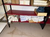 a red shelf that has a lot of items on it