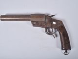 a close up of a gun on a table with a white background