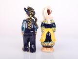 two figurines of people standing next to each other