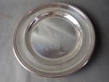 silver plate with beaded edge on a table top