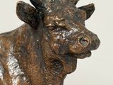 a statue of a cow that is standing on a table