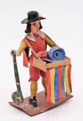 a figurine of a man holding a surfboard and a surfboard