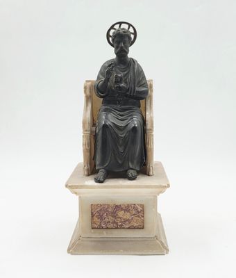 statue d'un homme assis sur un trône, avec une croix sur la tête
