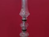 a close up of a glass candle holder on a red background
