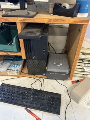 a computer desk with a keyboard, monitor, mouse and printer