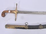 two different types of swords on display on a table