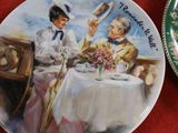 a plate with a picture of two people sitting at a table