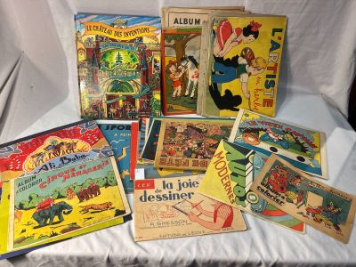 various vintage children ' s books on a bed with a white sheet