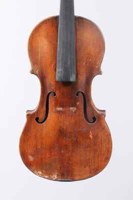 an old violin sitting on a white surface with a white background
