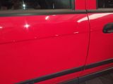 a red car that is parked on the side of the street