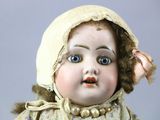 a close up of a doll with a hat on