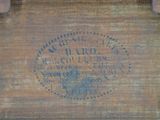 an old wooden box that has a label on it