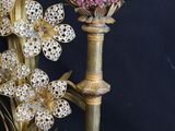 flowers in a vase on a table with a black background