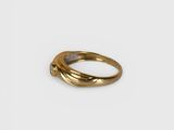 a close up of a gold ring on a white surface