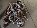 a pile of chains on the ground next to a pair of shoes