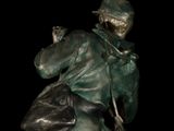 bronze statue of a man with a dog on a black background