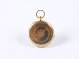 an image of a gold pocket watch with a picture of a woman on it