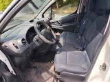the interior of a car with the door open and the driver ' s seat down